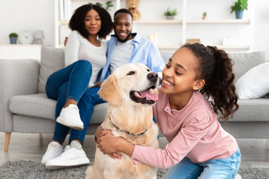 Family relaxing at home with a Golden Retriever, representing compassionate veterinary care in Scottsdale