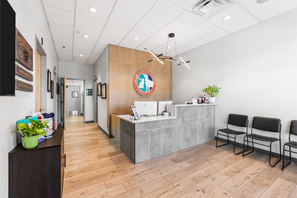 Bright Phoenix Mobile Veterinarians lobby with reception desk, seating, and branded wall logo